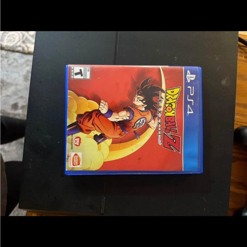 PlayStation 4 with two controllers and Dragonball Z Kakorat